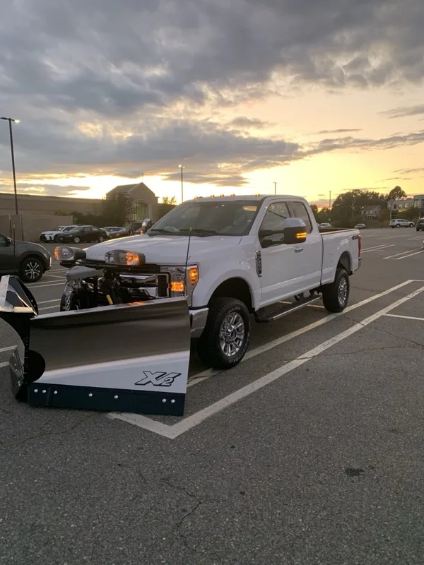 Marotta Landscaping snow plow truck at dusk